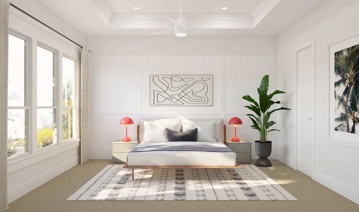 Primary suite with decorative feature wall and tray ceiling