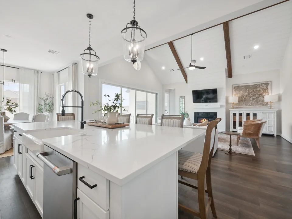 Kitchen overlooking great room with stained ceiling beams