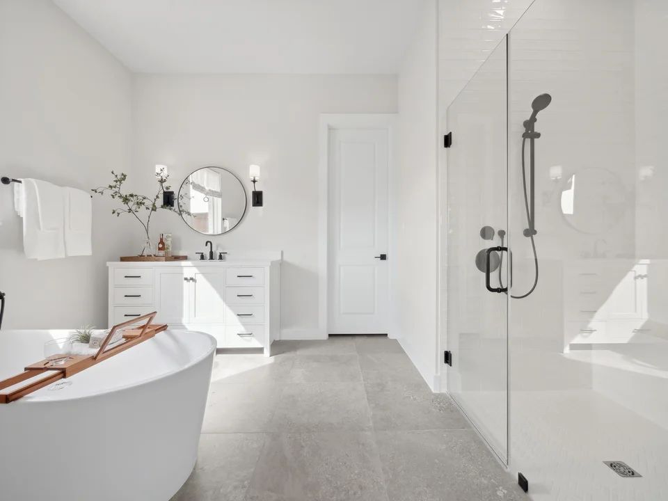 Primary bath with glass shower enclosure and freestanding tub