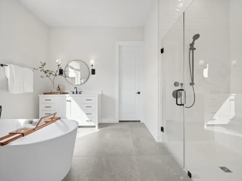Primary bath with glass shower enclosure and freestanding tub