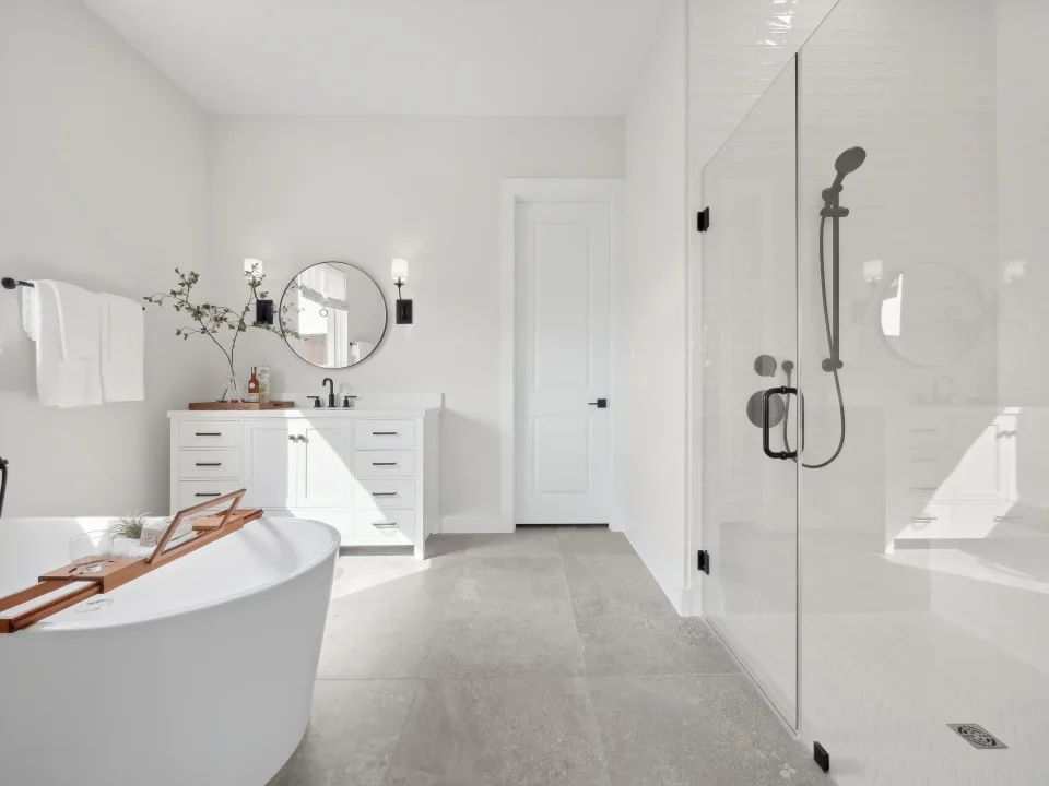 Primary bath with glass shower enclosure and freestanding tub