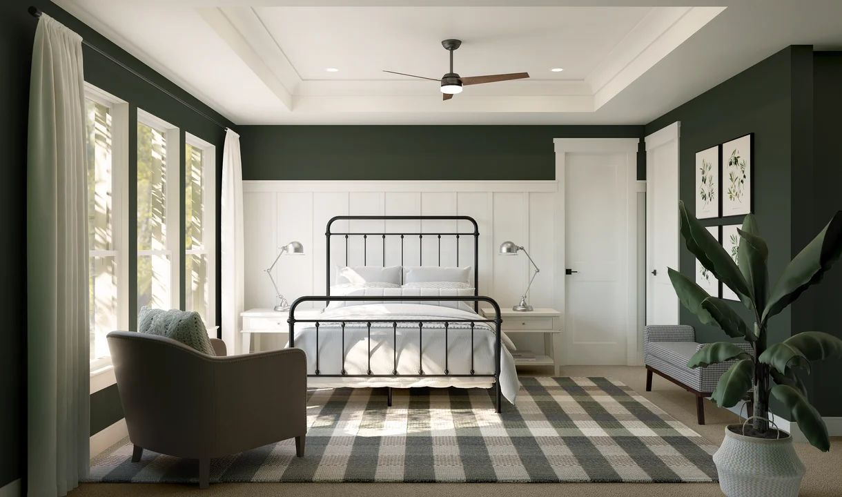 Primary suite with decorative feature wall and tray ceiling with crown moulding