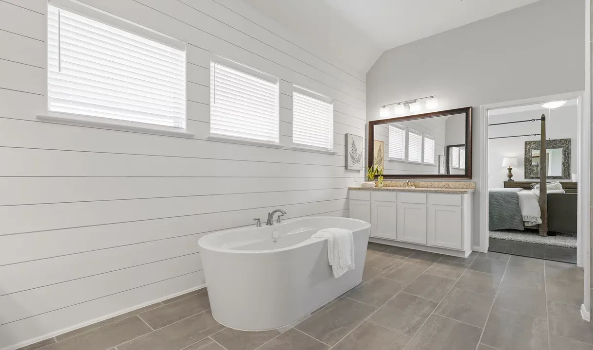 Owner's luxury bath with freestanding soaking tub and dual vanities