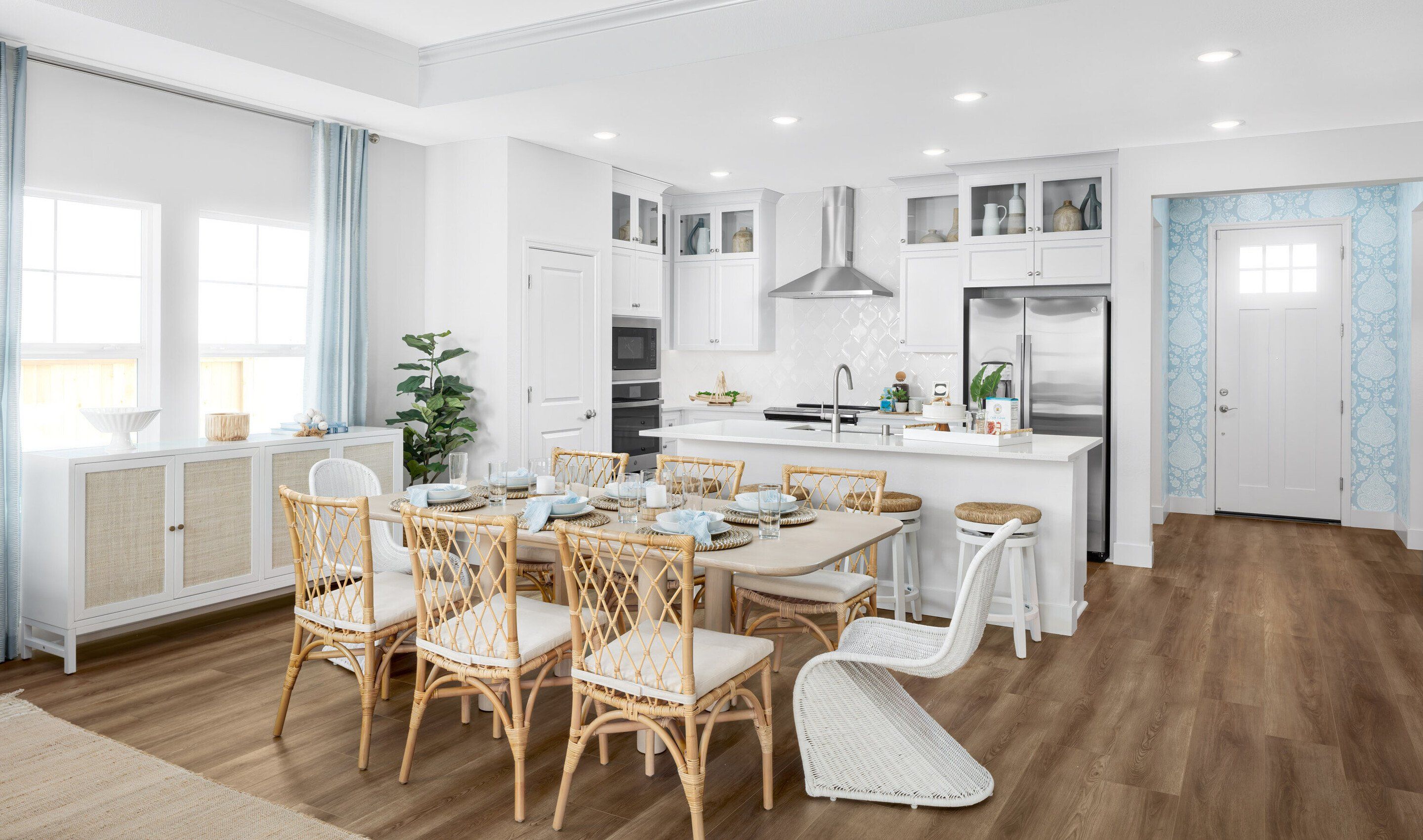 Kitchen with glass upper cabinets and dining area