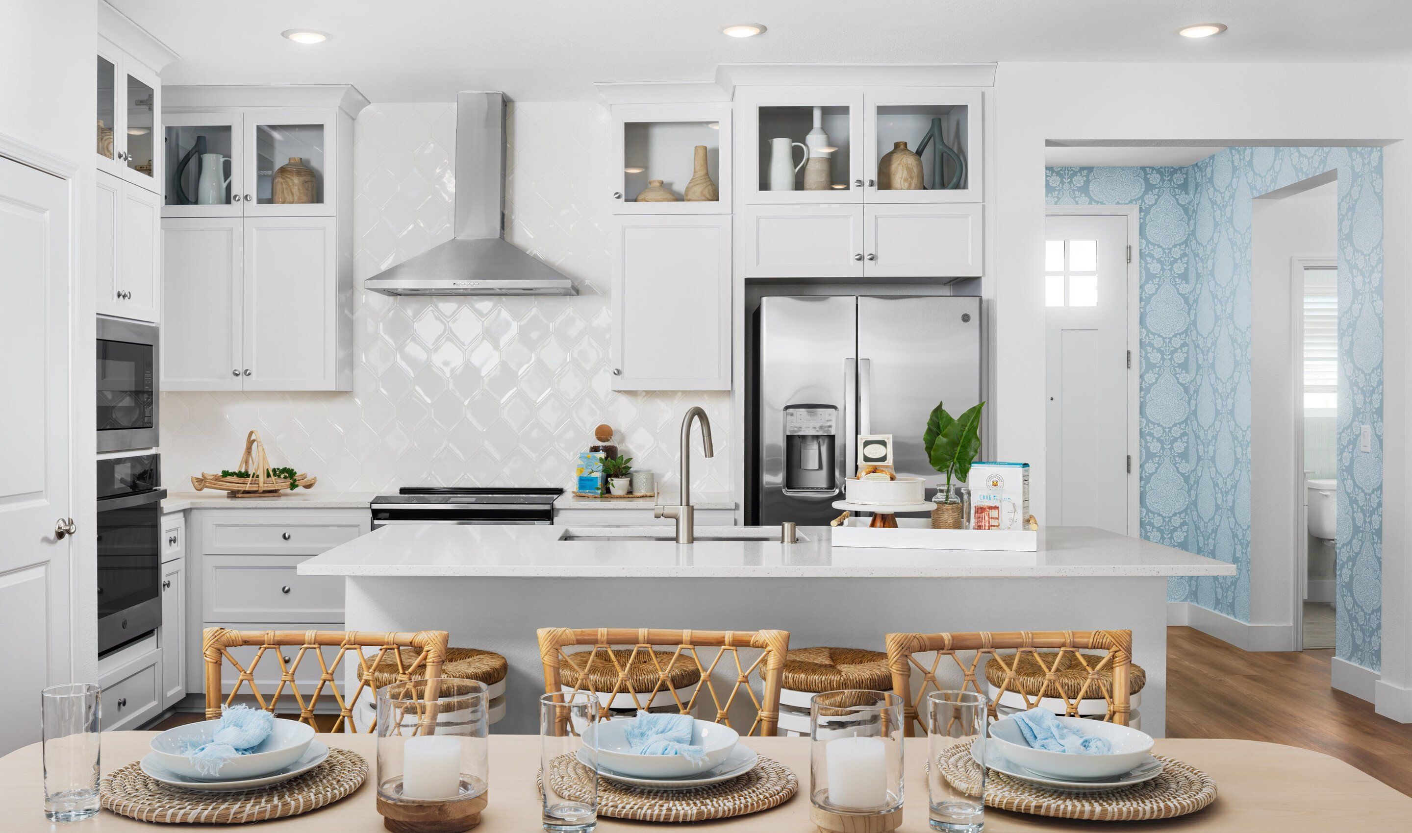 Dining area and kitchen with glass upper cabinets