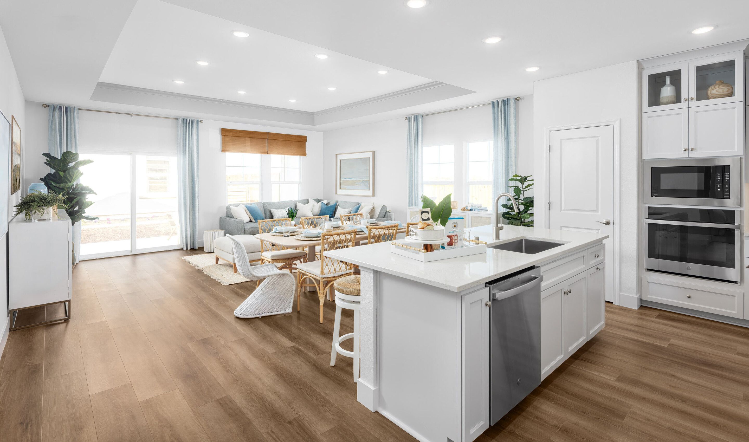 Kitchen overlooking the great room with luxurious wood flooring
