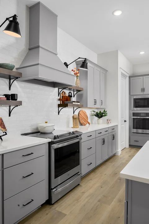 Kitchen with subway tile backsplash and gorgeous hood vent