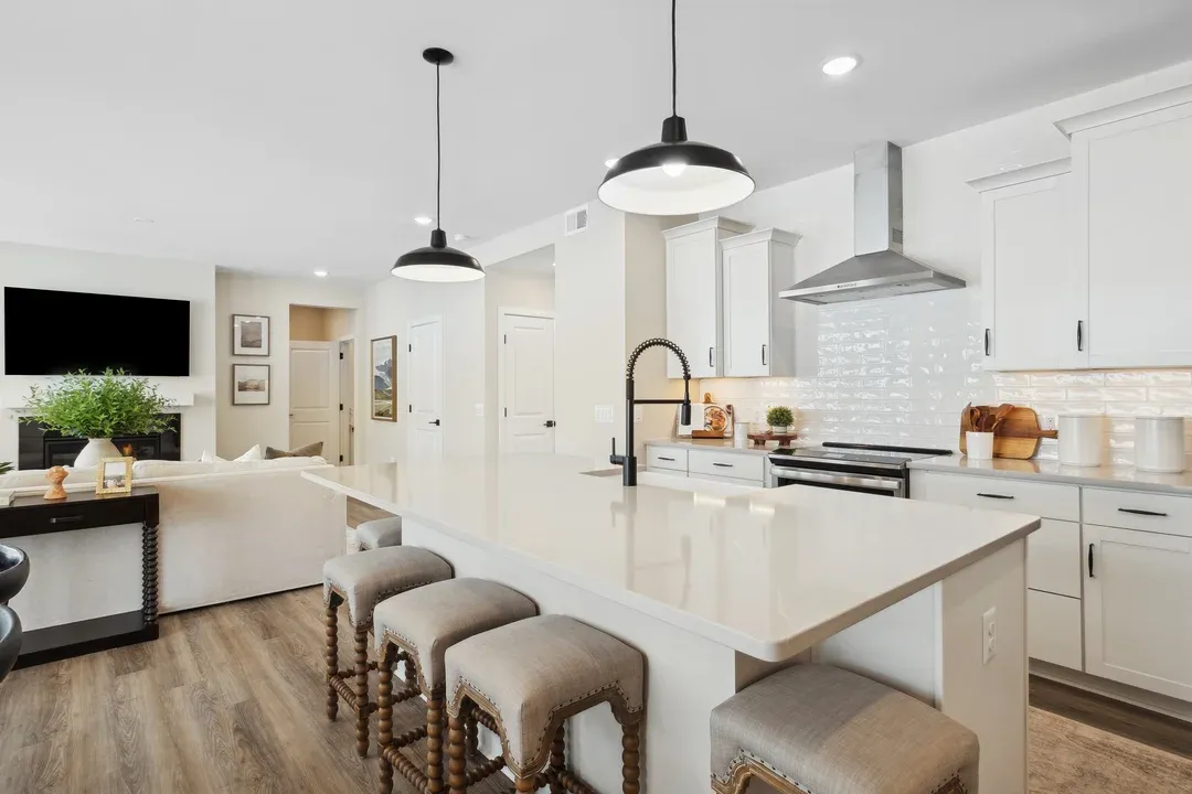 Kitchen featuring vast island and pendant lights