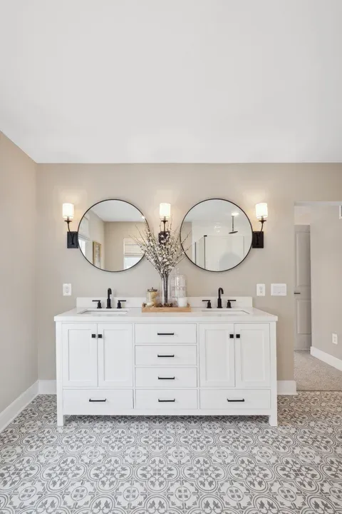 Primary bath featuring freestanding vanity with dual sinks