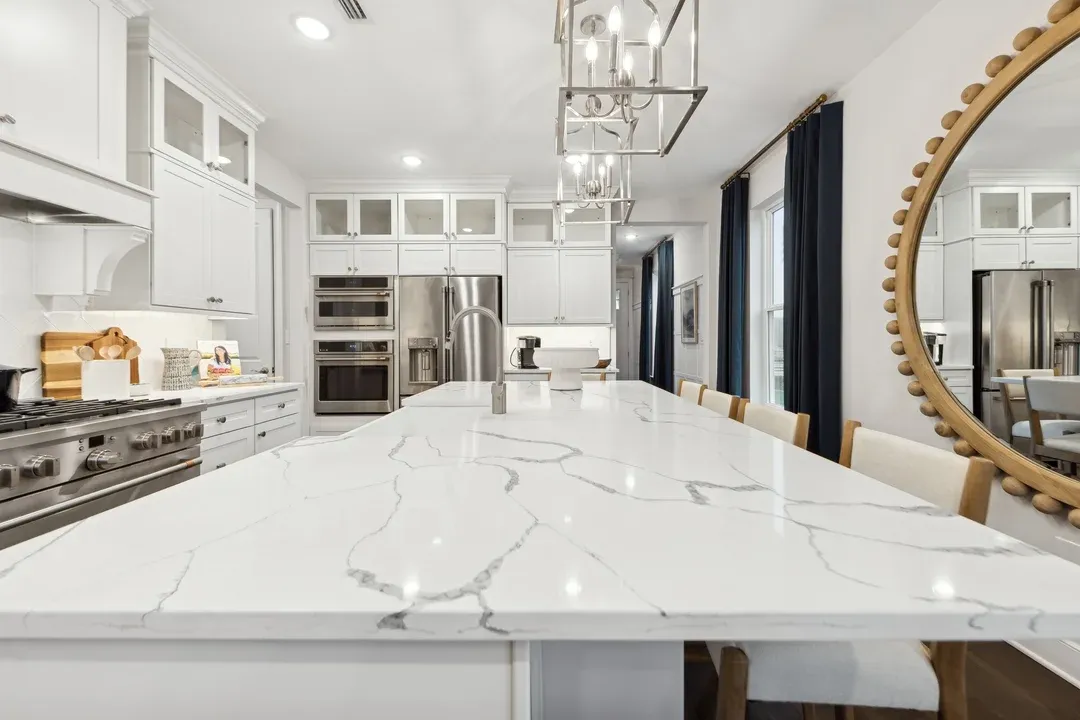 Kitchen features quartz island and countertops