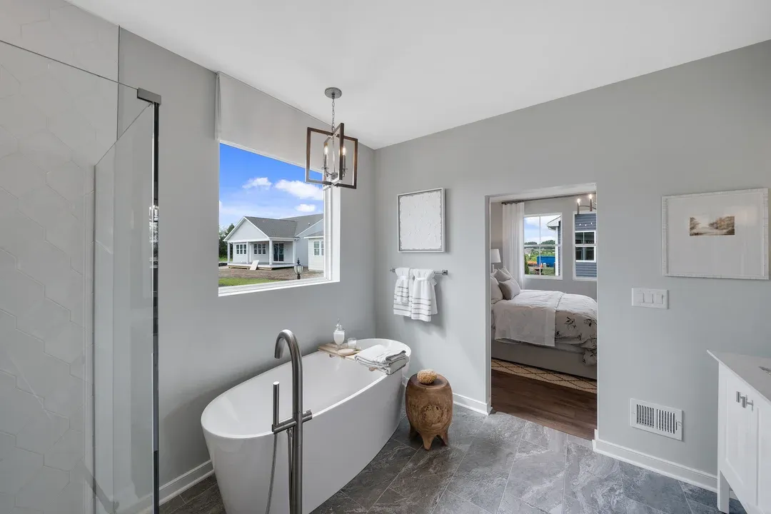 Primary bath with freestanding white tub