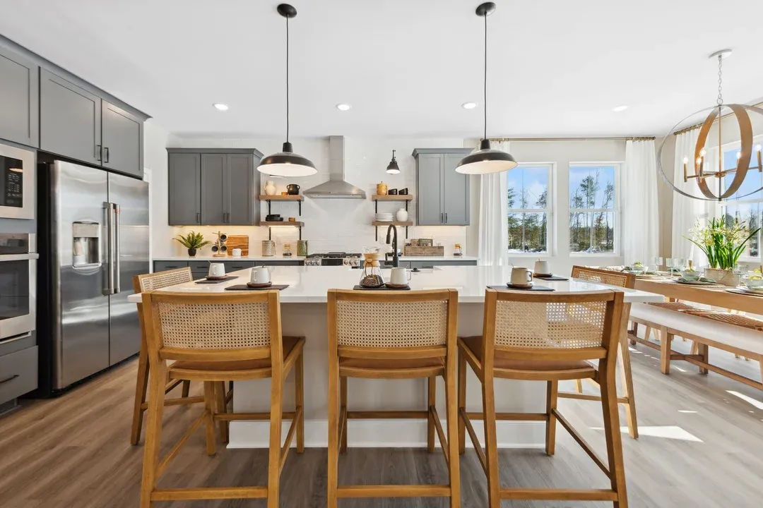 Kitchen with pendant lights and quartz island