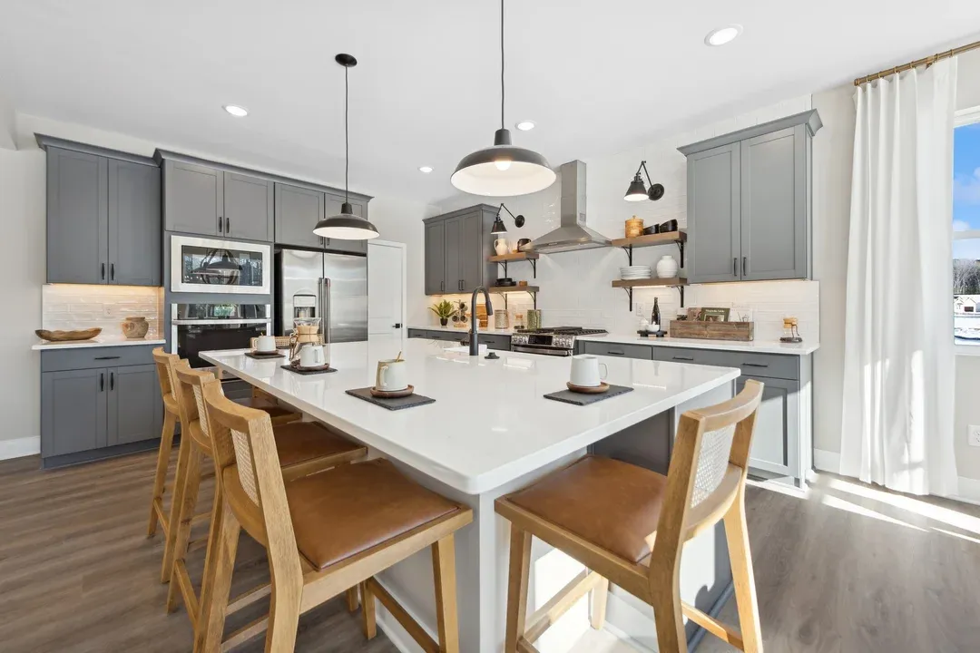 Kitchen with floating shelves and grey cabinets