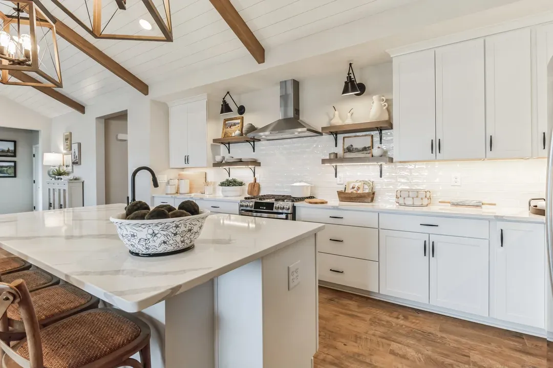 Kitchen with white cabinets and pendant lights