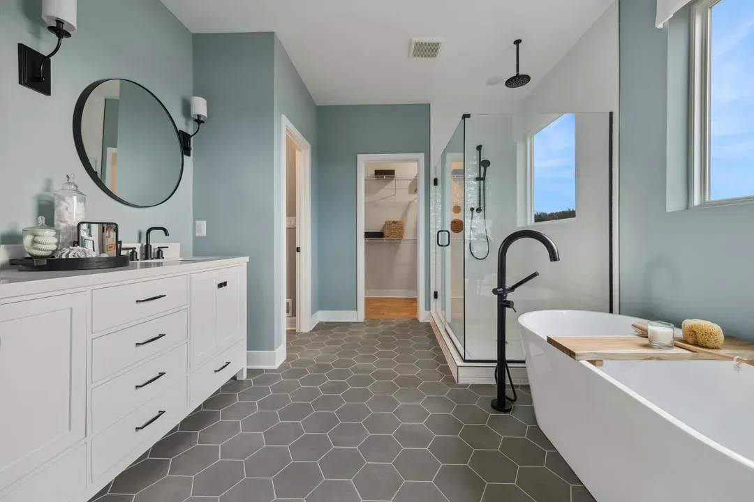 Primary bath with freestanding tub and glass shower enclosure