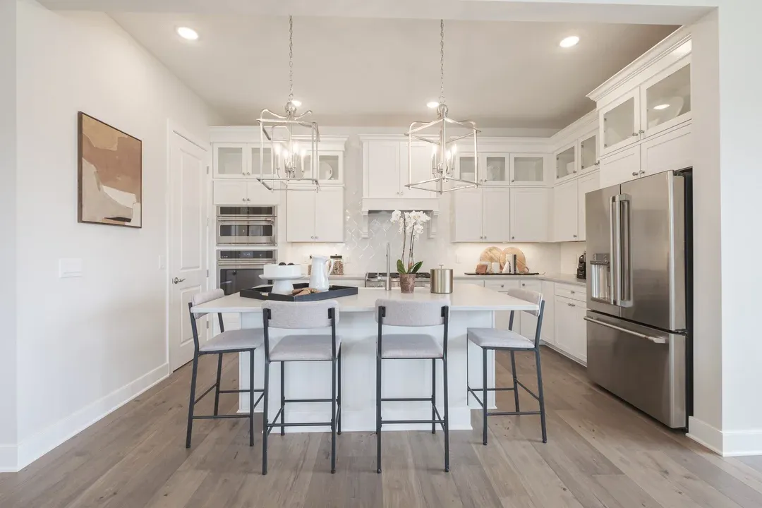 Kitchen with stacked glass-front upper cabinets over solid lowers