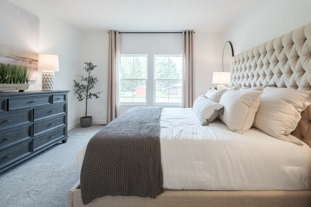 Bright primary suite with plush carpeting