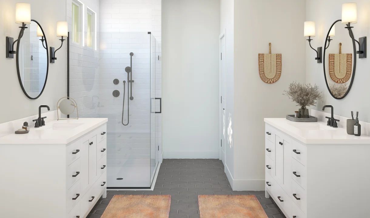Primary bath with dual vanities and glass shower enclosure