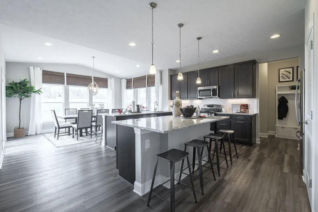 Kitchen flows into morning room with vaulted ceiling
