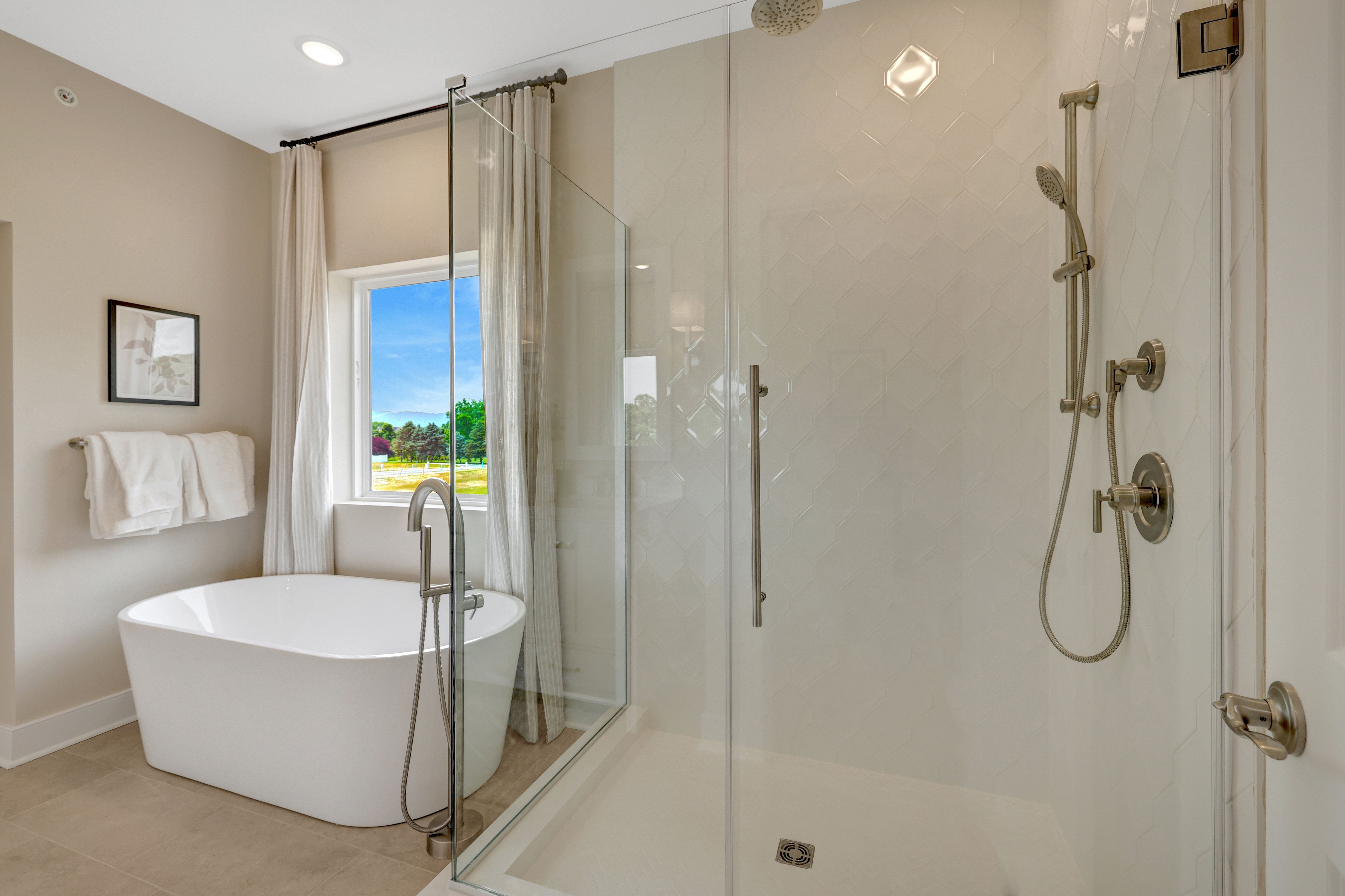 Primary bath with freestanding tub and glass shower enclosure