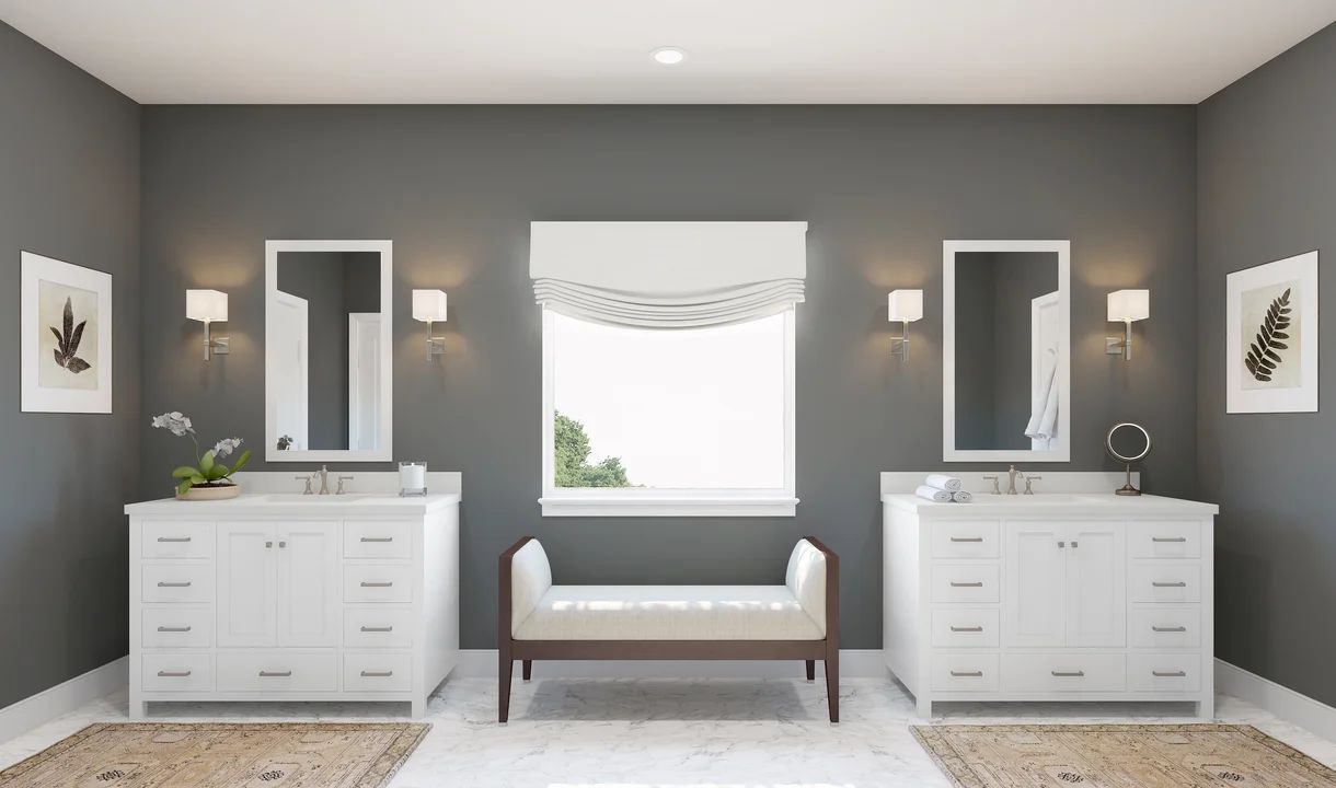 Primary bath features dual freestanding vanities