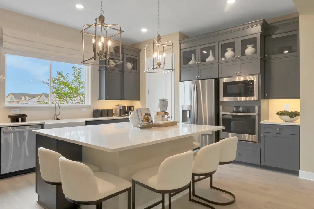 Kitchen with upper glass cabinets and pendant lighting