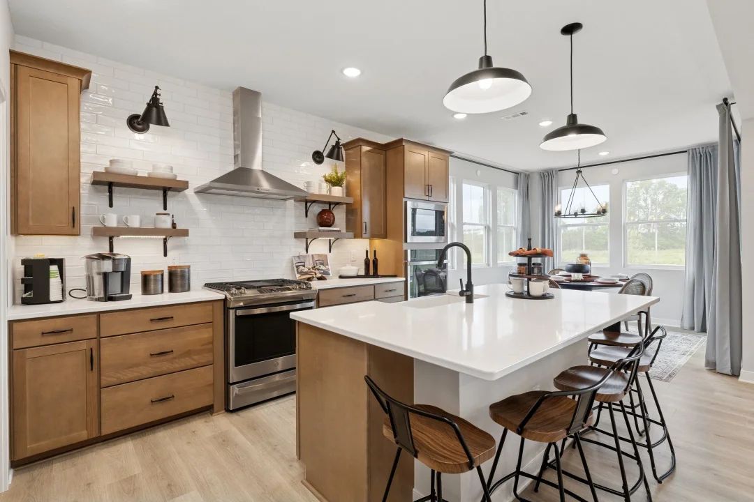 Kitchen with pendant lighting and subtle wood stained cabinets