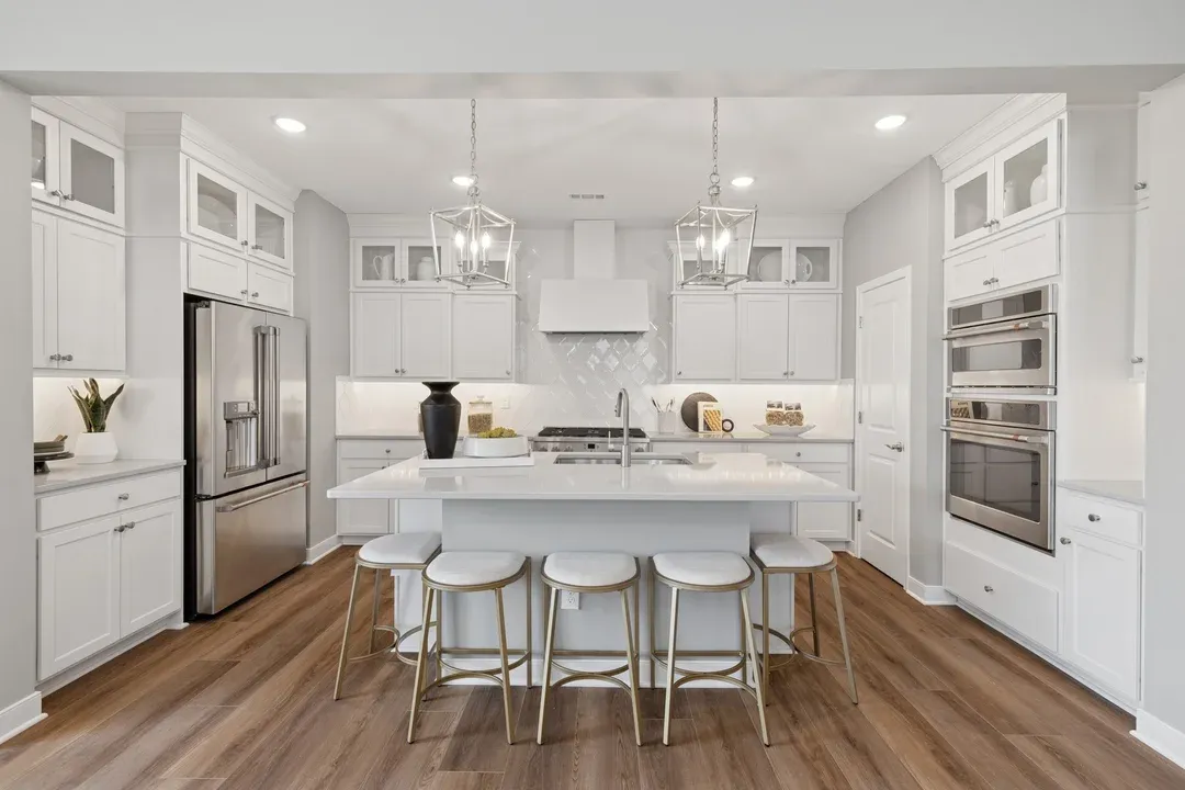 Kitchen with pendant lights and upper glass cabinets