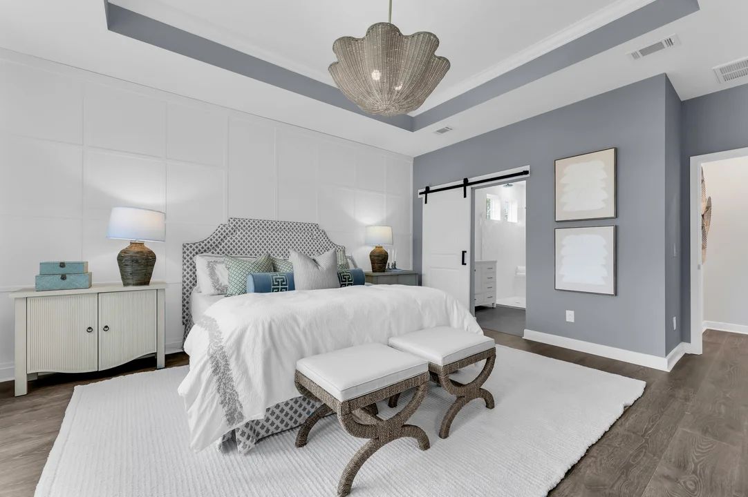 Primary suite with barn door and decorative feature wall