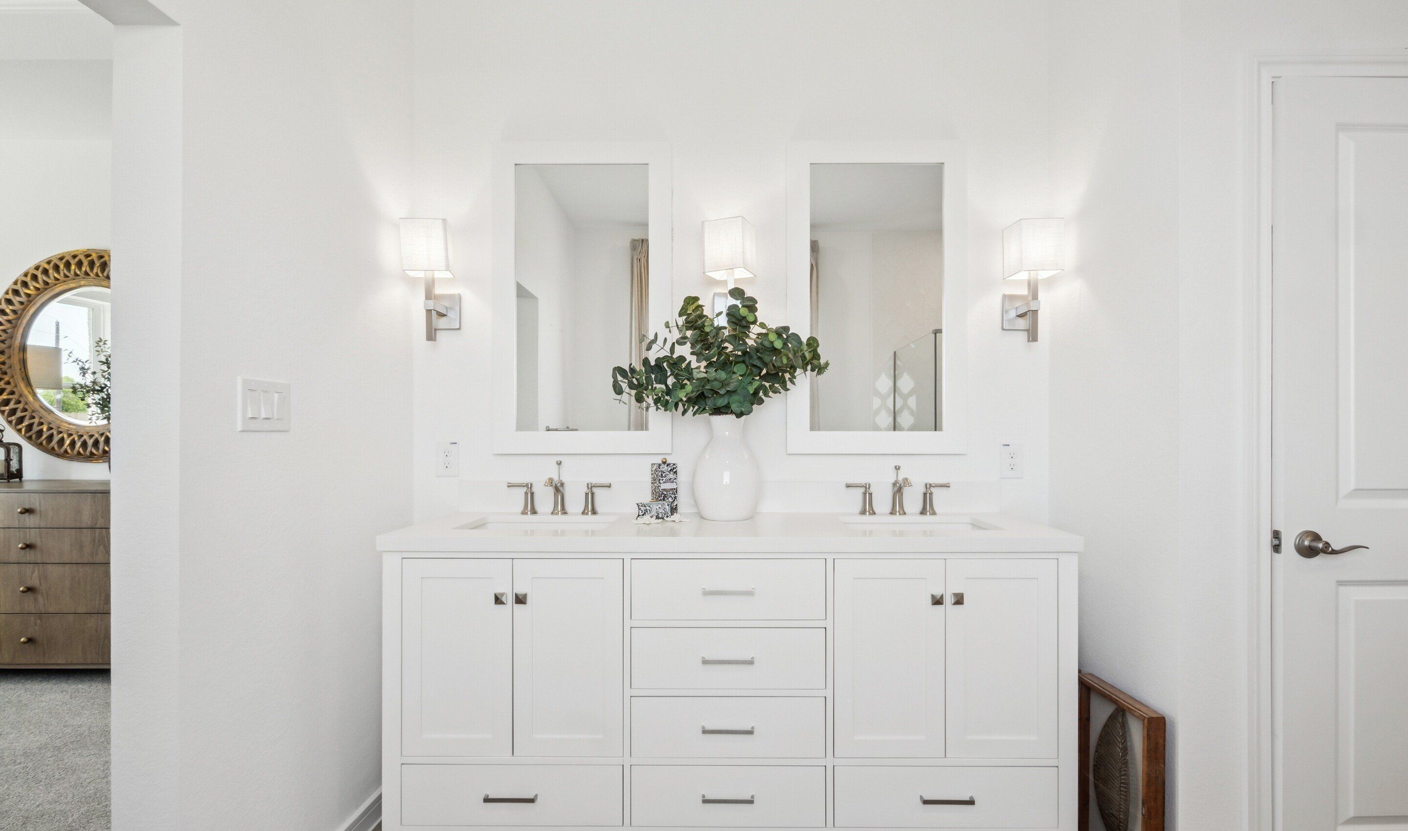 Primary bath features freestanding vanity with dual sinks