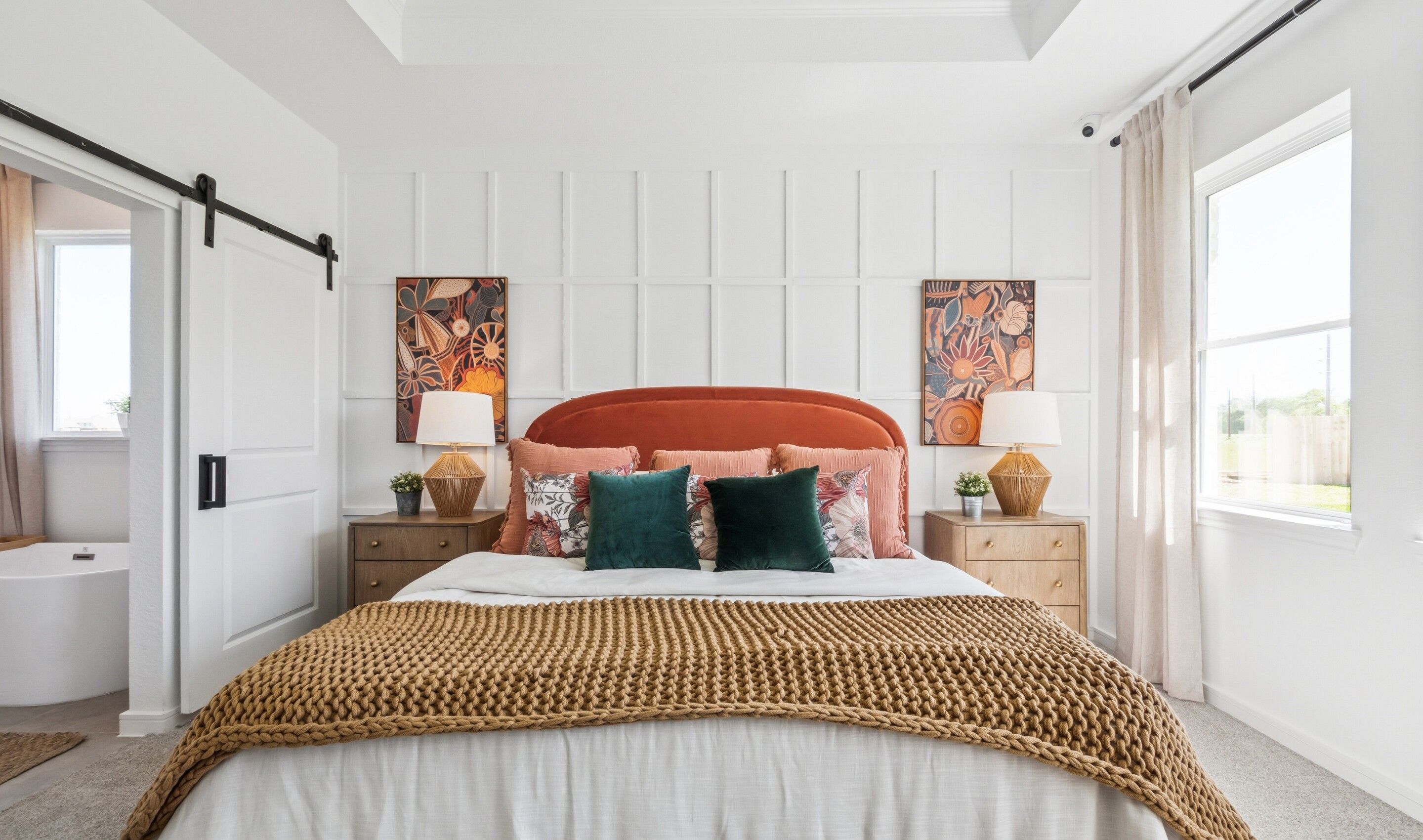 Primary suite with sliding barn door to primary bath