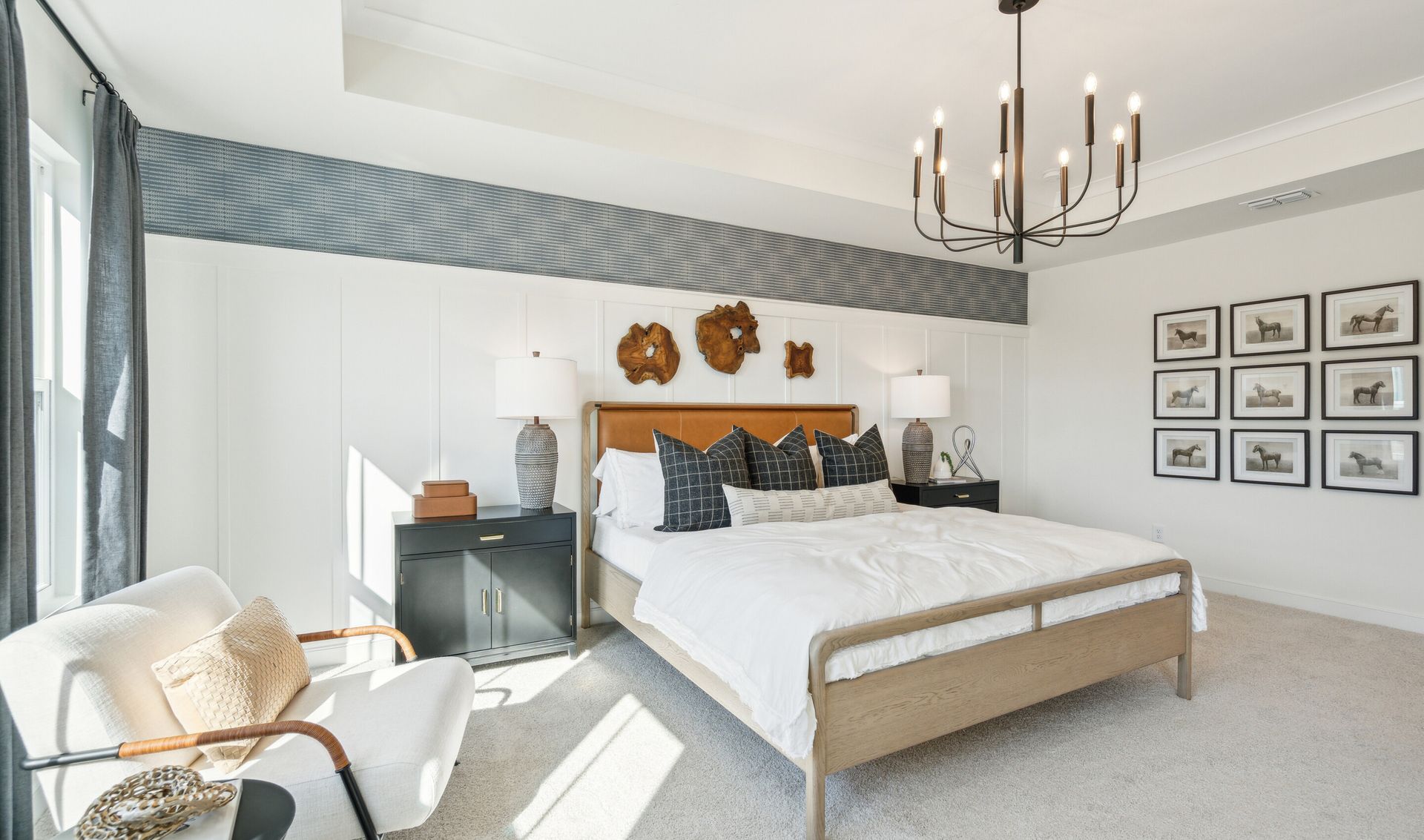 Primary suite with ceiling treatment and chandelier