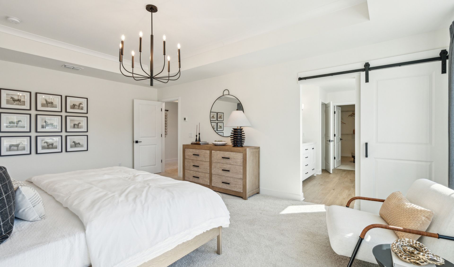 Primary suite with sliding barn door to private bath