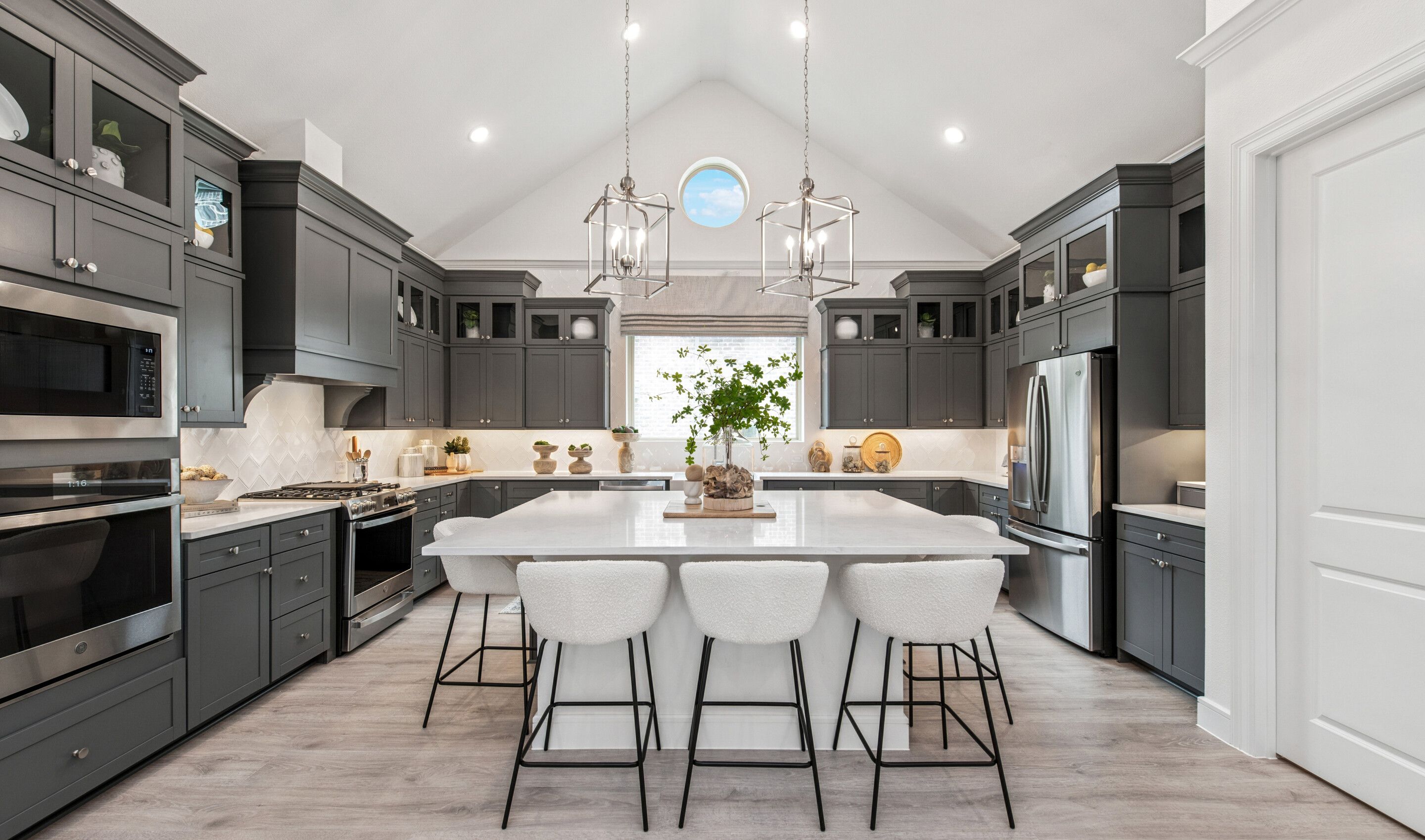Kitchen with stunning stacked cabinetry with glass-front uppers