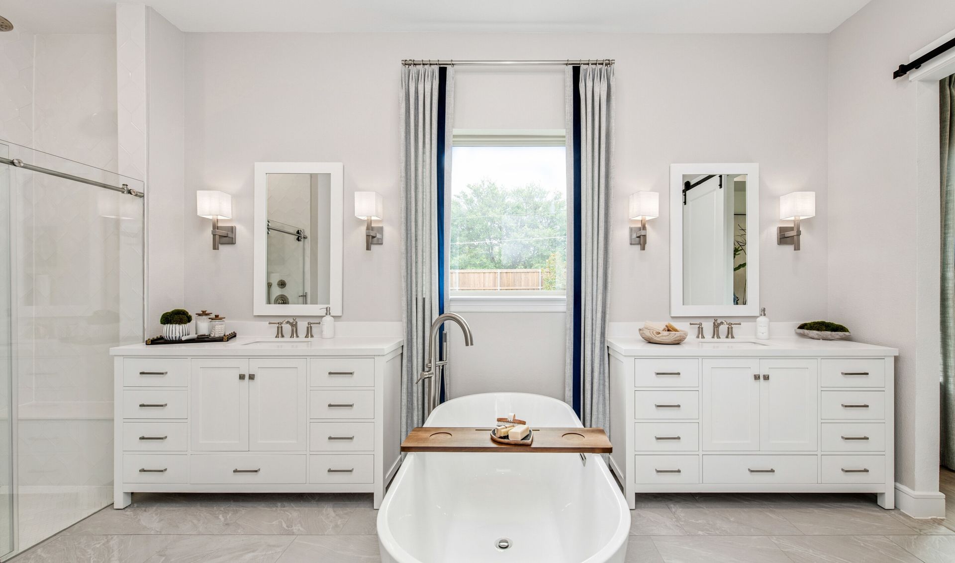 Primary bath with dual freestanding vanities