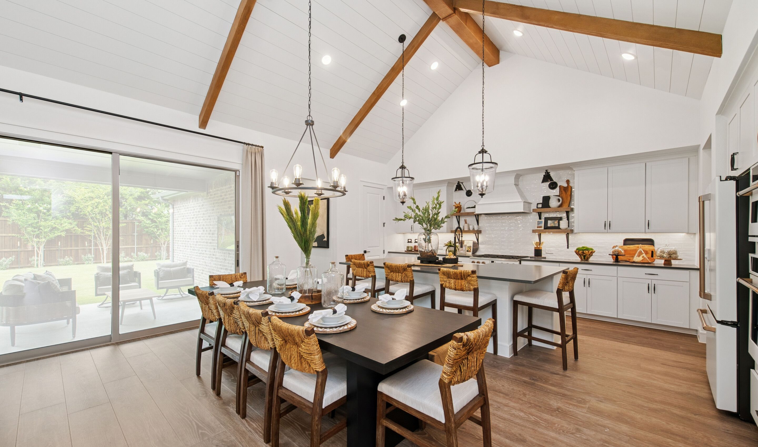 Dining area and kitchen with vaulted ceiling and stained ceiling beams