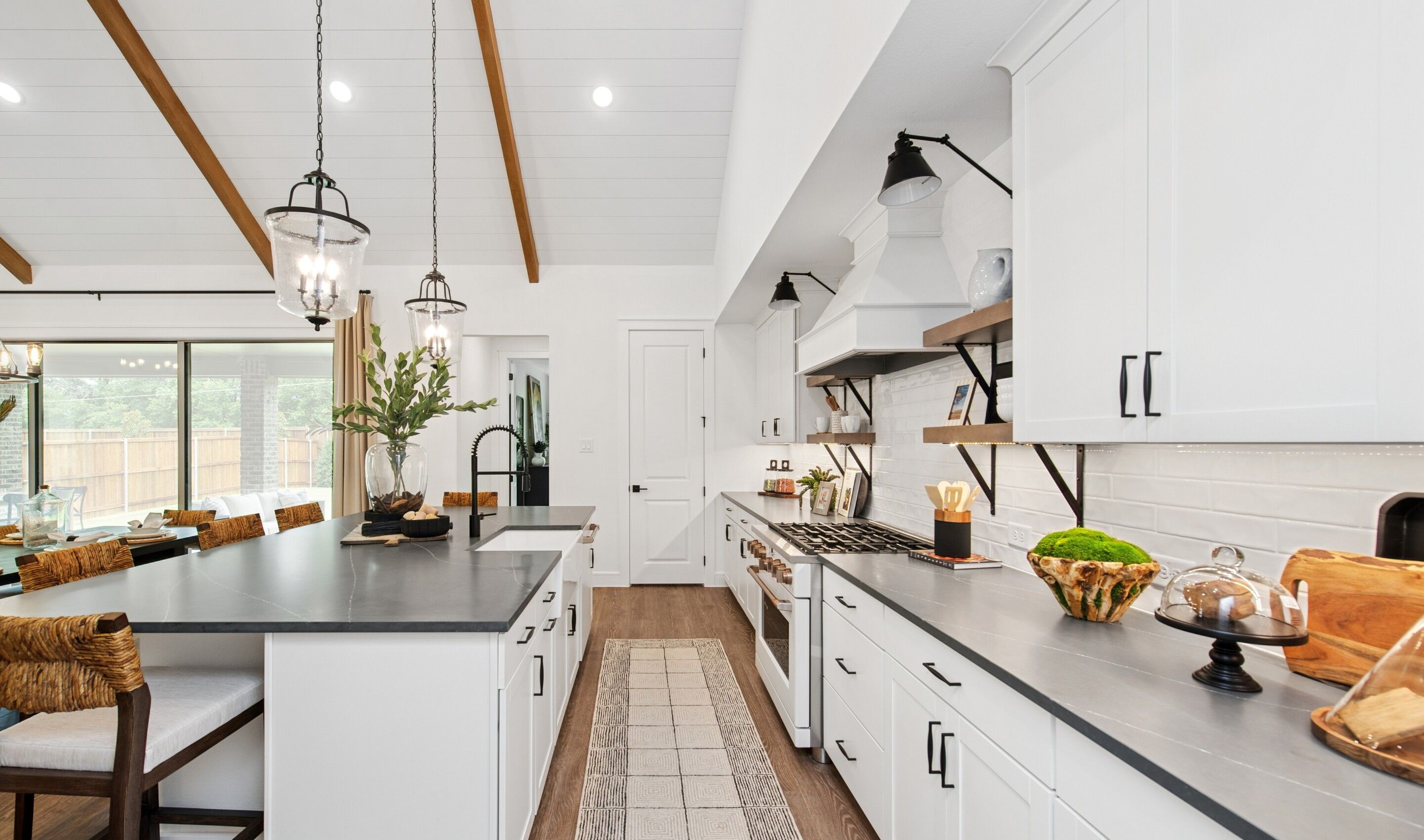 Kitchen with floating shelves and white subway tile backsplash
