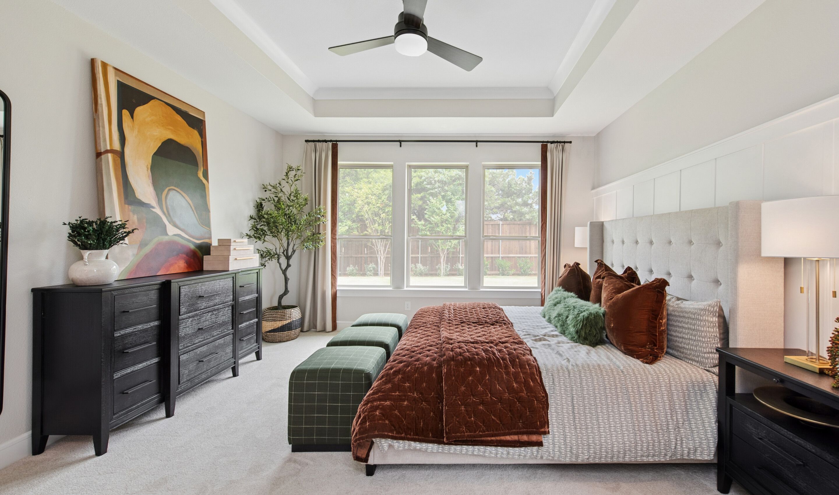 Primary suite with crown moulding and decorative feature wall