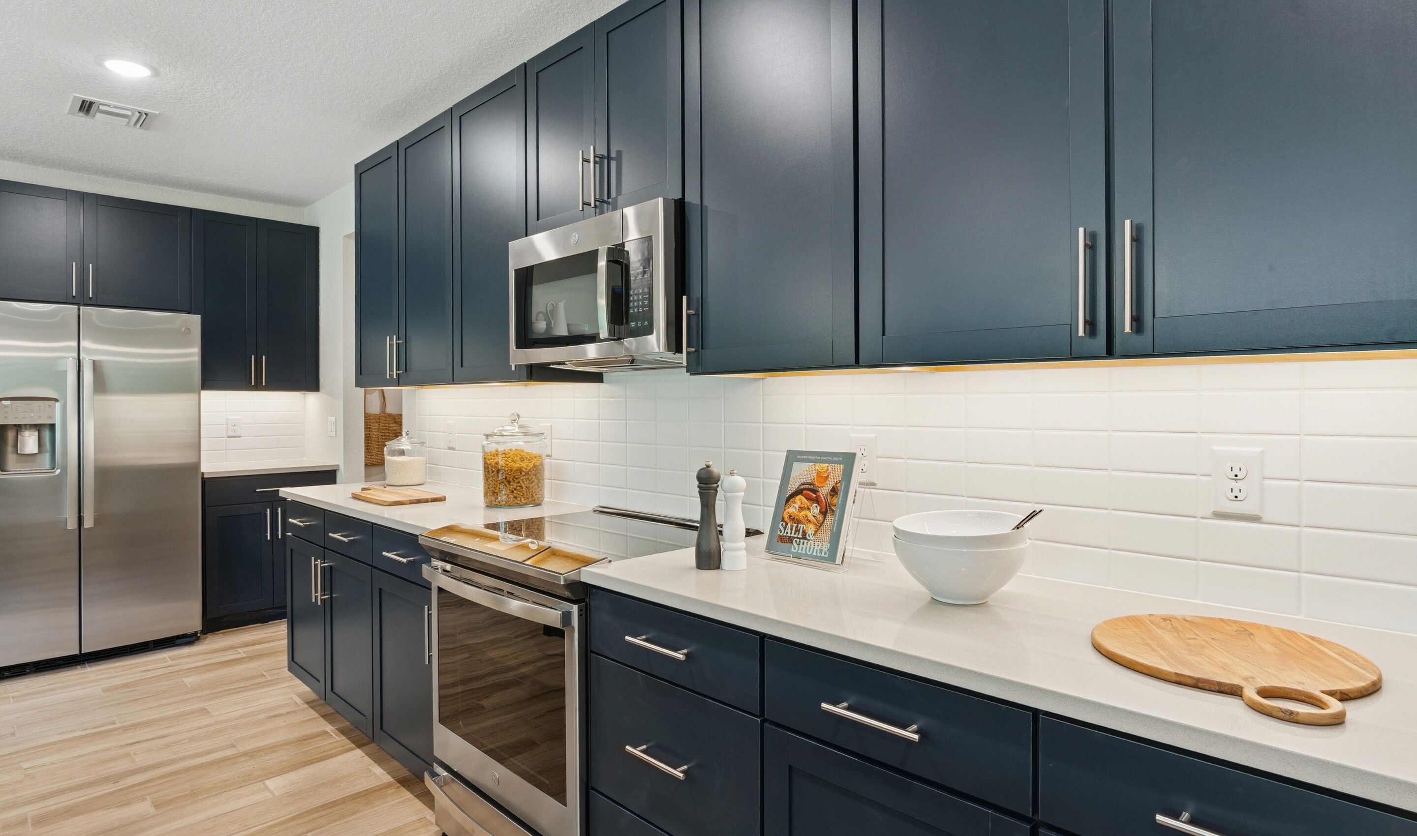 Kitchen with blue cabinets and quartz countertops