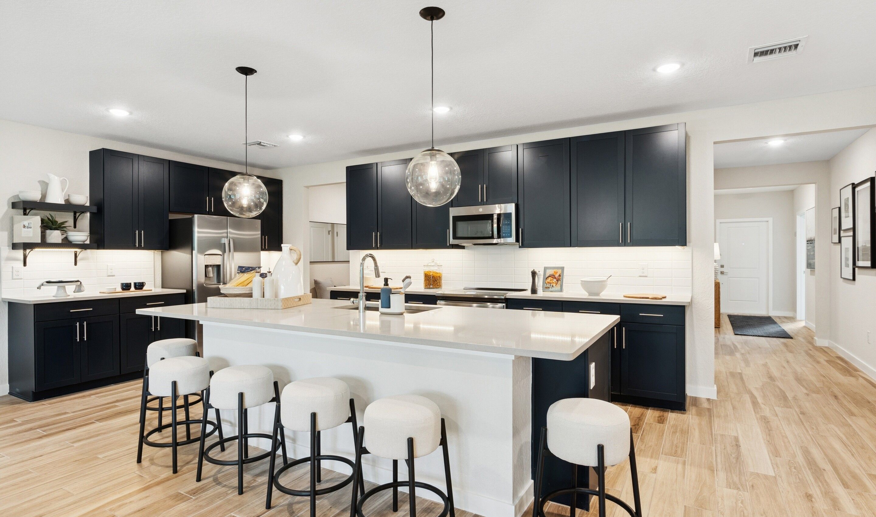 Kitchen with pendant lighting and floating shelves