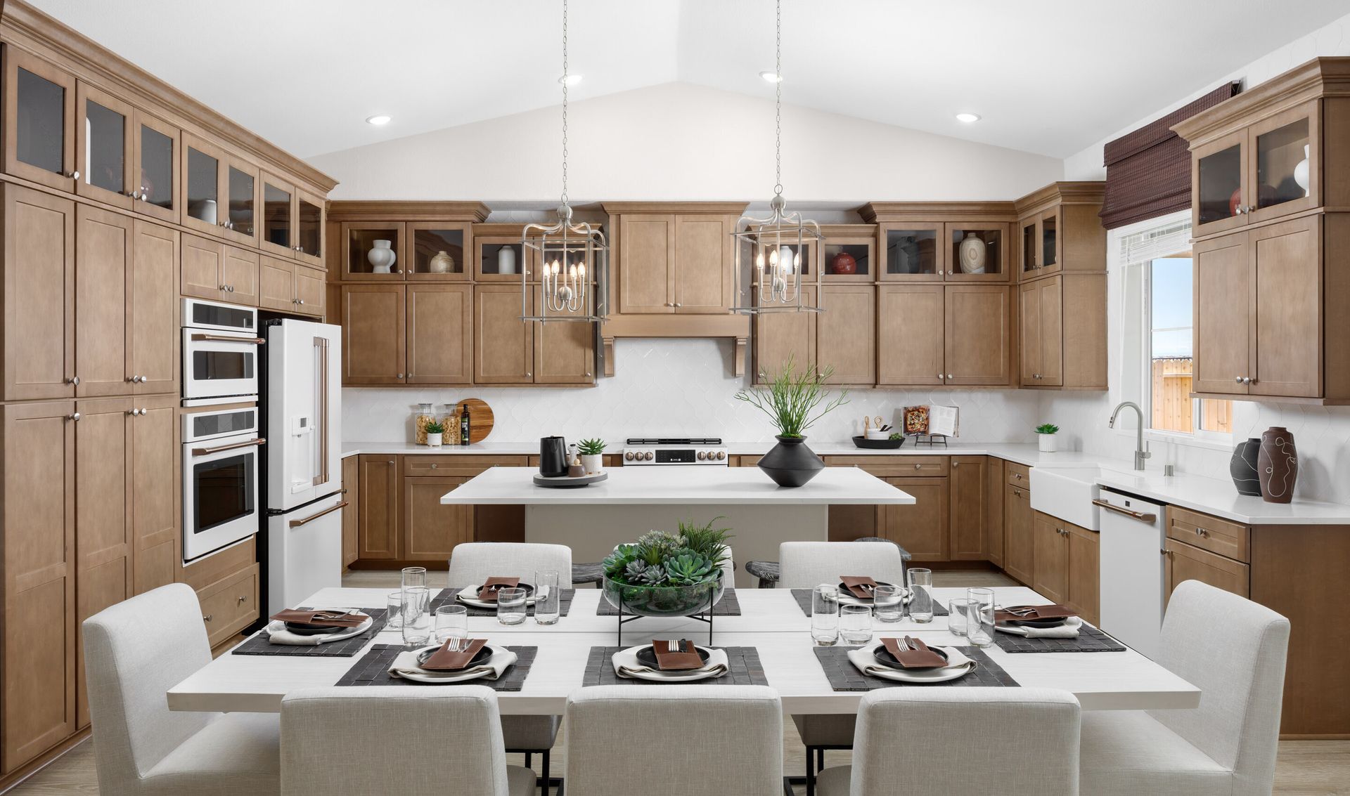 Dining area adjacent to kitchen with stunning pendant lights