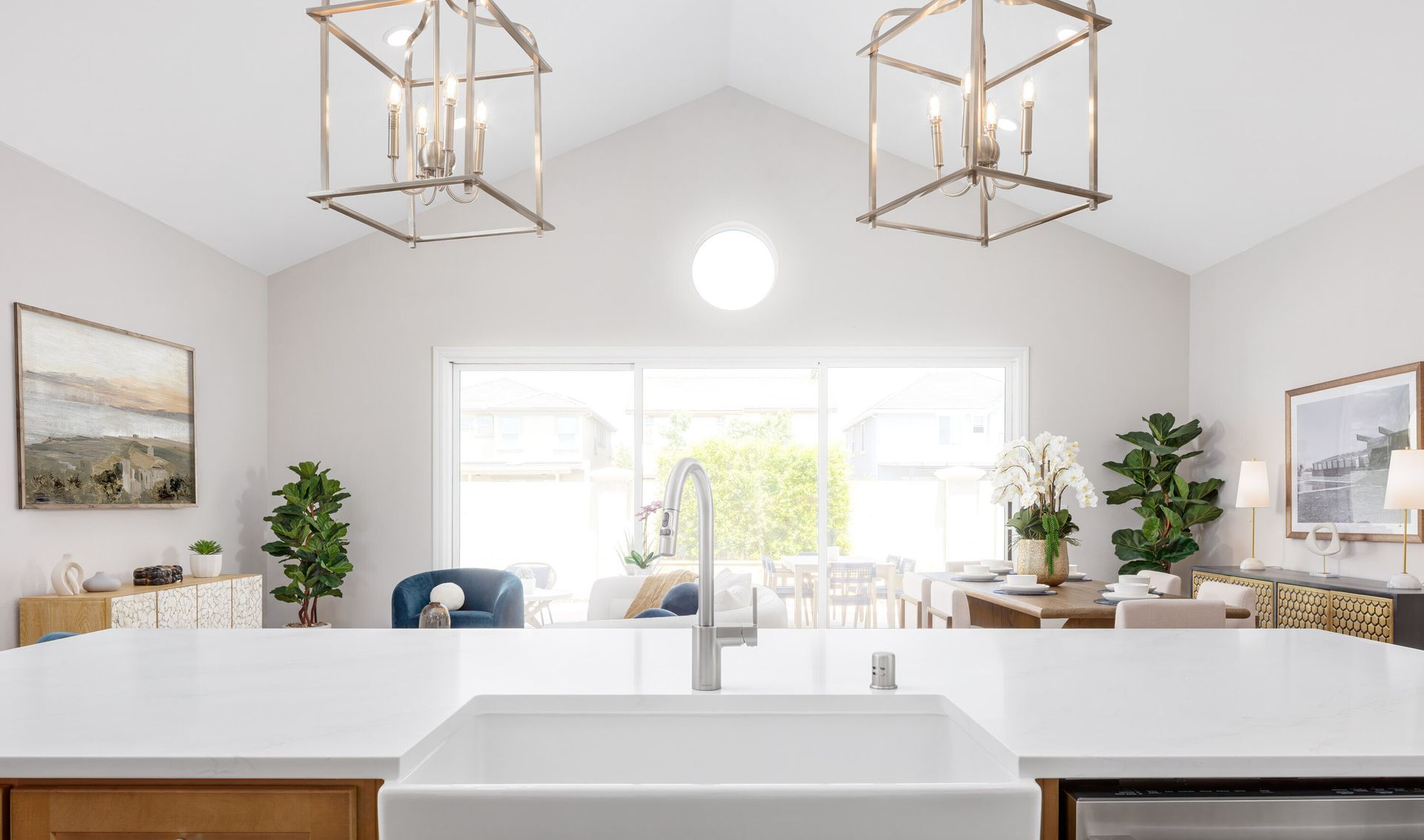 Pendant lighting and white apron-front sink