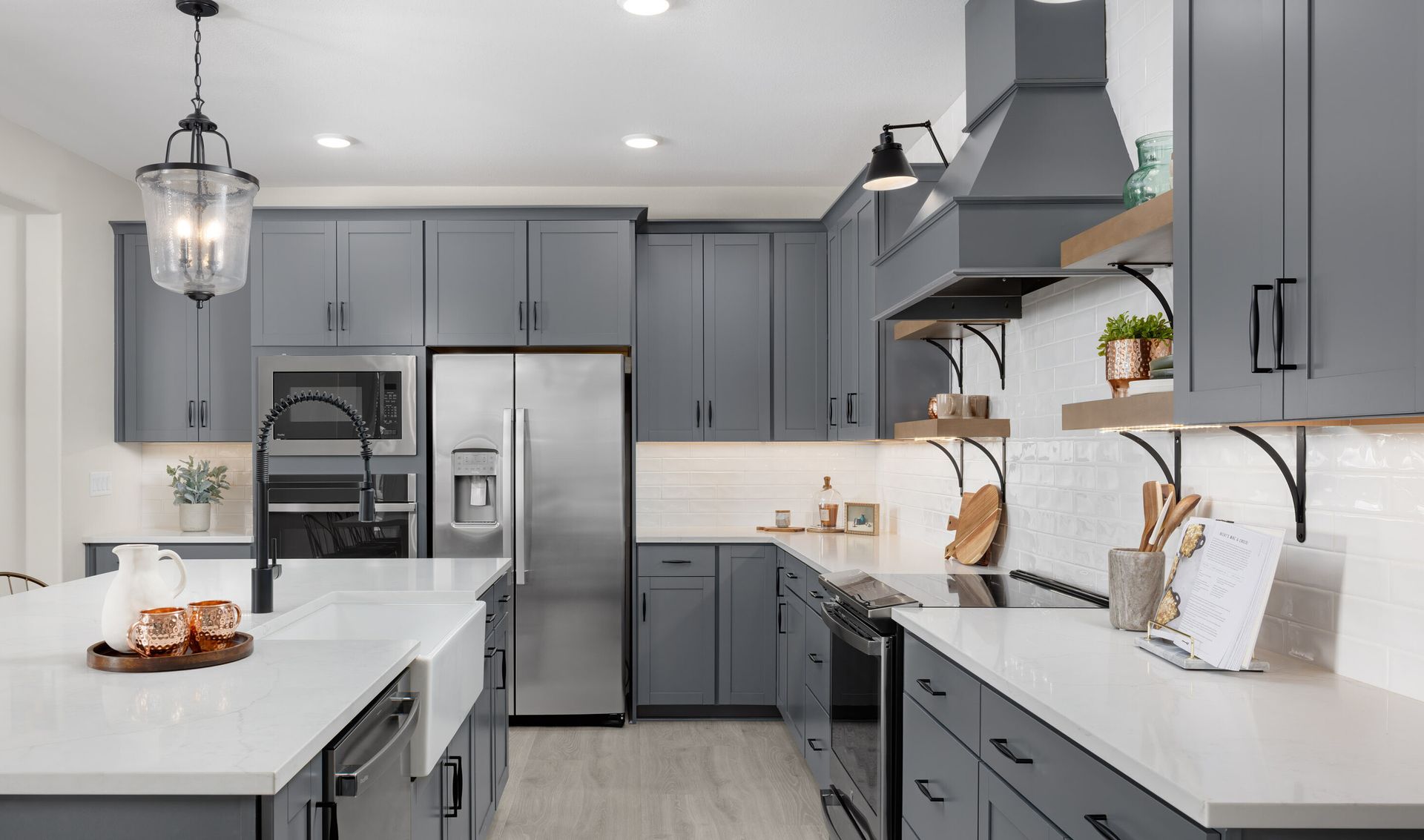 Kitchen with floating shelves and gorgeous vent-hood