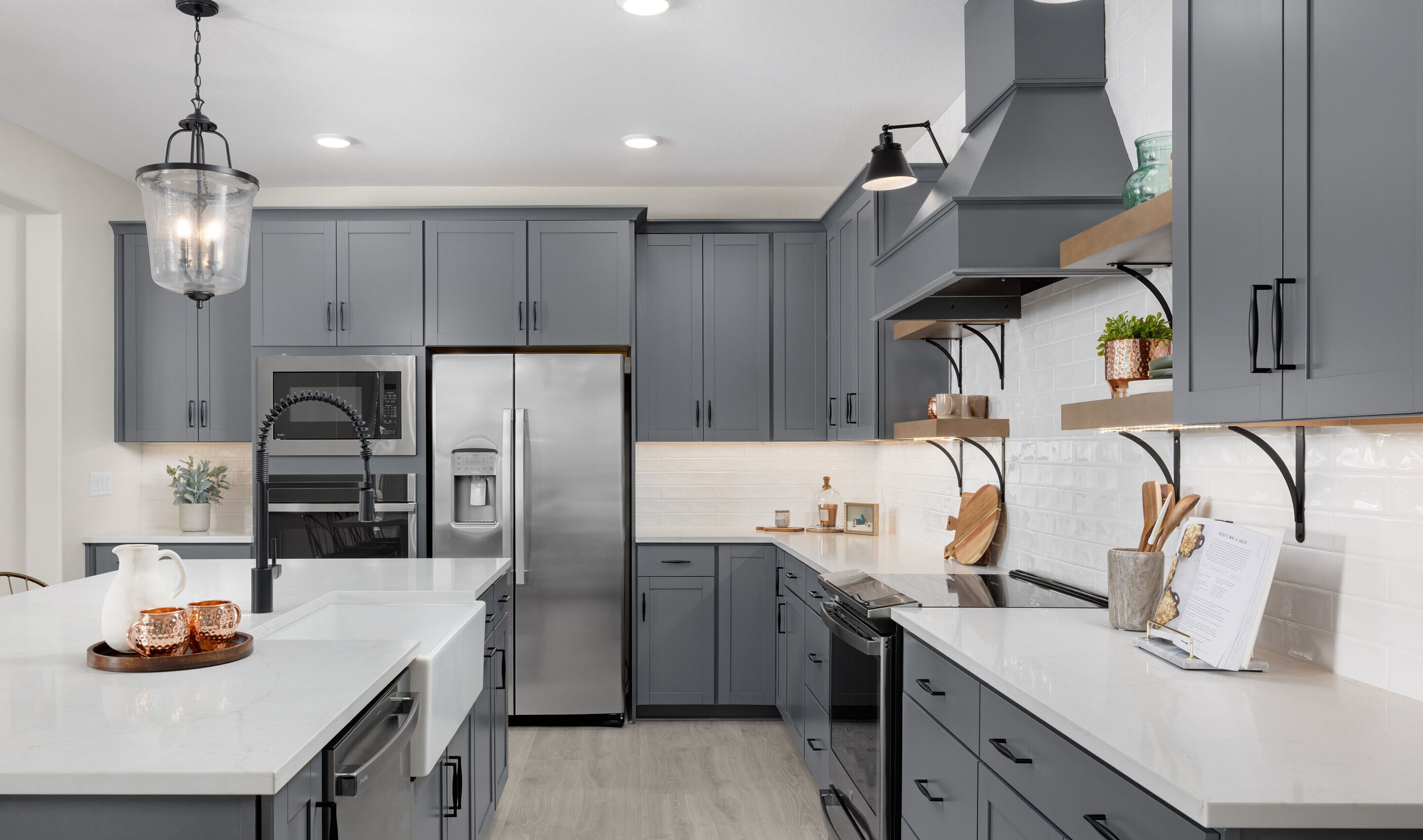 Kitchen with floating shelves and gorgeous vent-hood