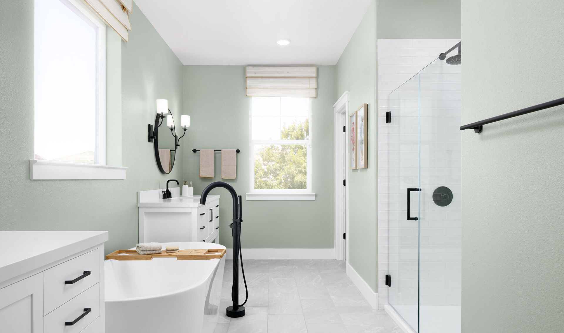 Glass shower enclosure with stylish tile and matte black fixtures