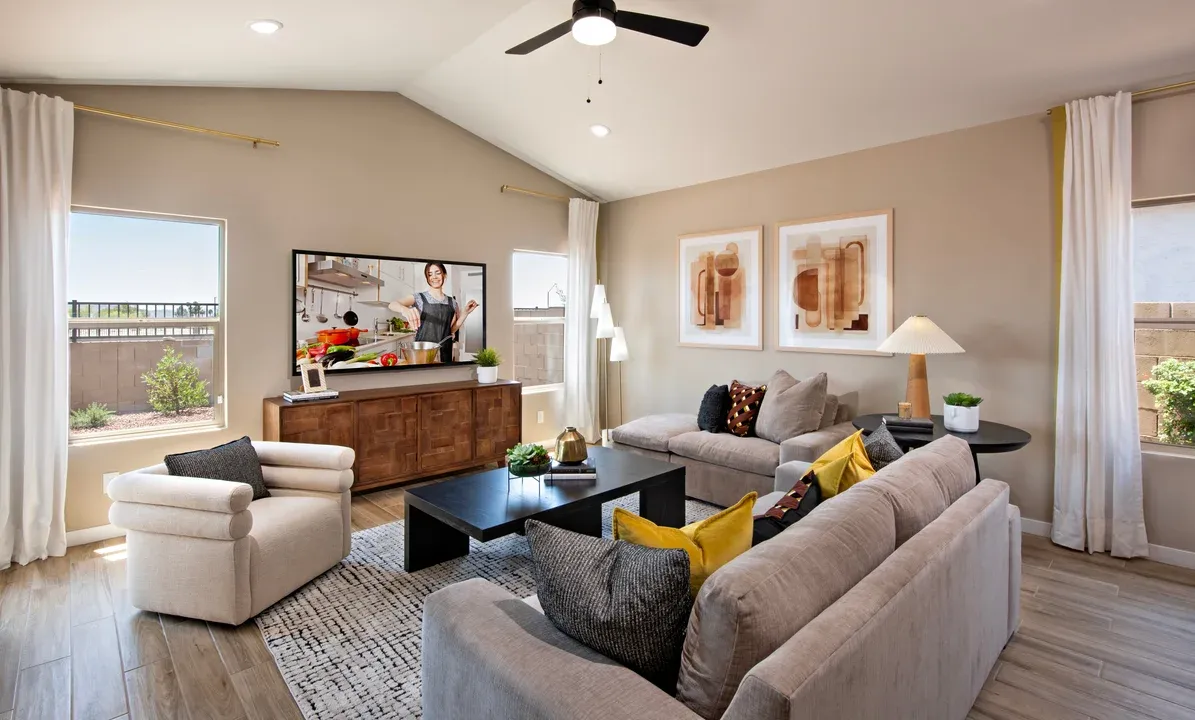 Great room with vaulted ceiling and ceiling fan