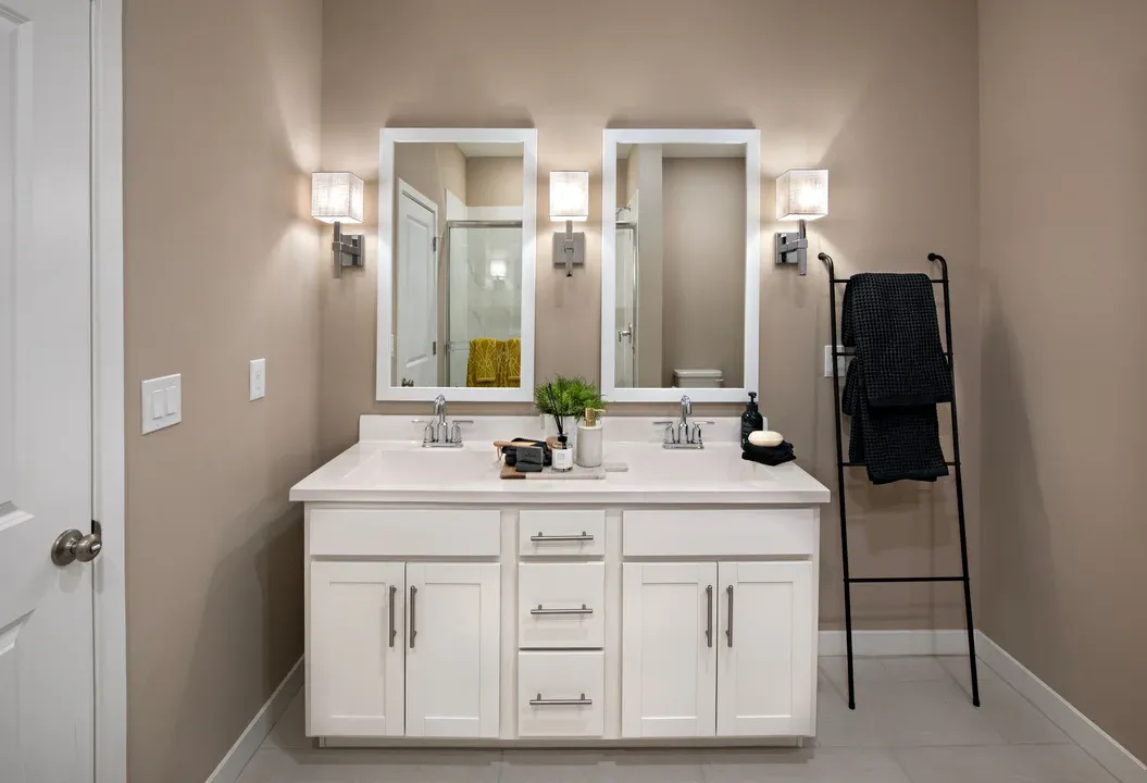 Primary bath with chrome fixtures and glass shower enclosure