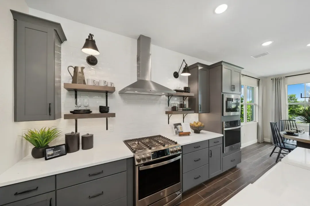 Kitchen with floating shelves and white tile backsplash