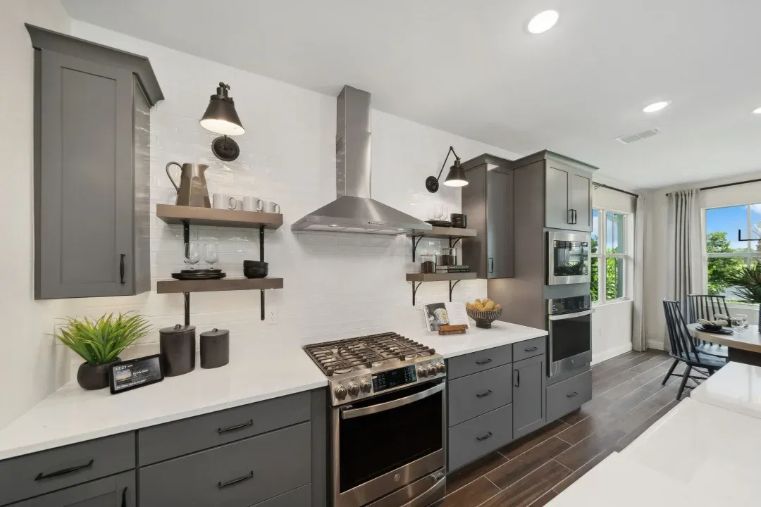 Kitchen with floating shelves and white tile backsplash