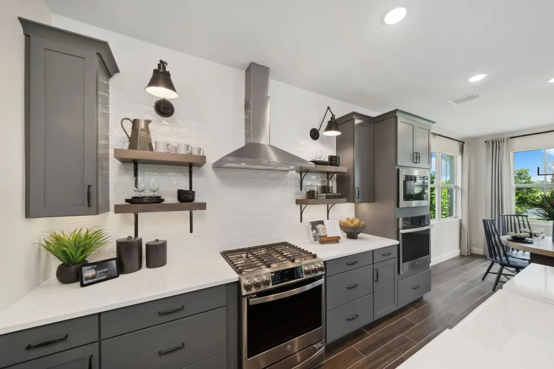 Kitchen with floating shelves and white tile backsplash